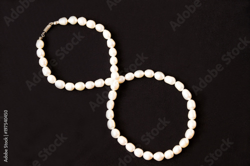 Women's jewelry made of pearls on dark velvet