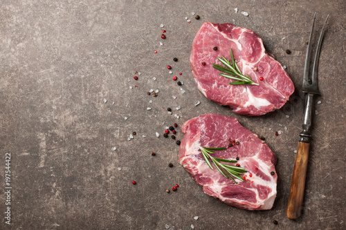 Raw pork steaks with rosemary and spices