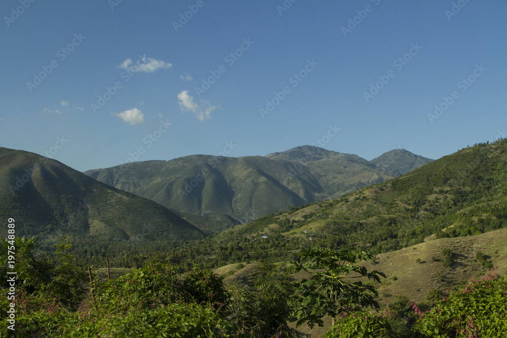 Fototapeta premium Haitian mountains and green valley at 'Grand Anse' region. Blue sky with clouds. / Haiti