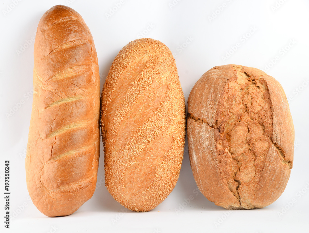 Loaves of bread isolated on white background. Wheat, rye, bread with sesame seeds.. Loaves of bread isolated on white background. Wheat, rye, bread with sesame seeds..