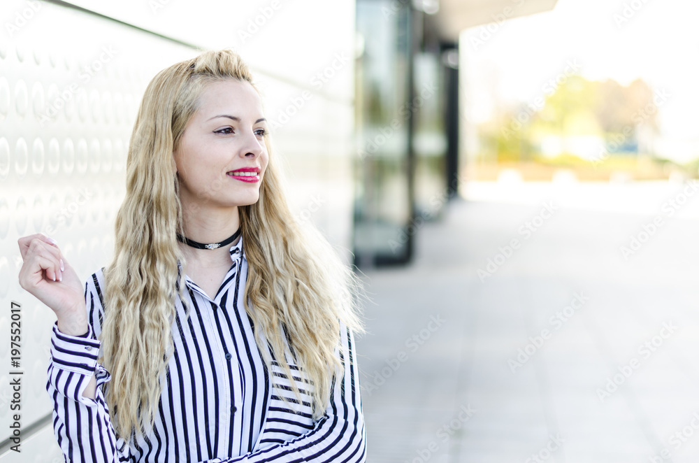 pretty blonde woman portrait at glass wall pretty blonde woman portrait at glass wall