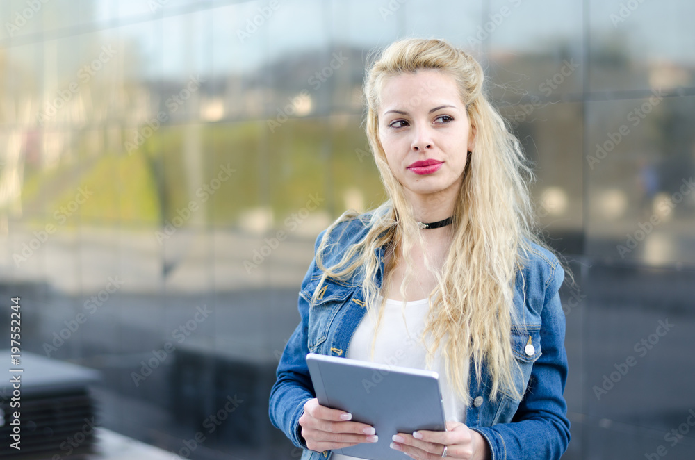 Fototapeta premium pretty young woman with tablet at the street