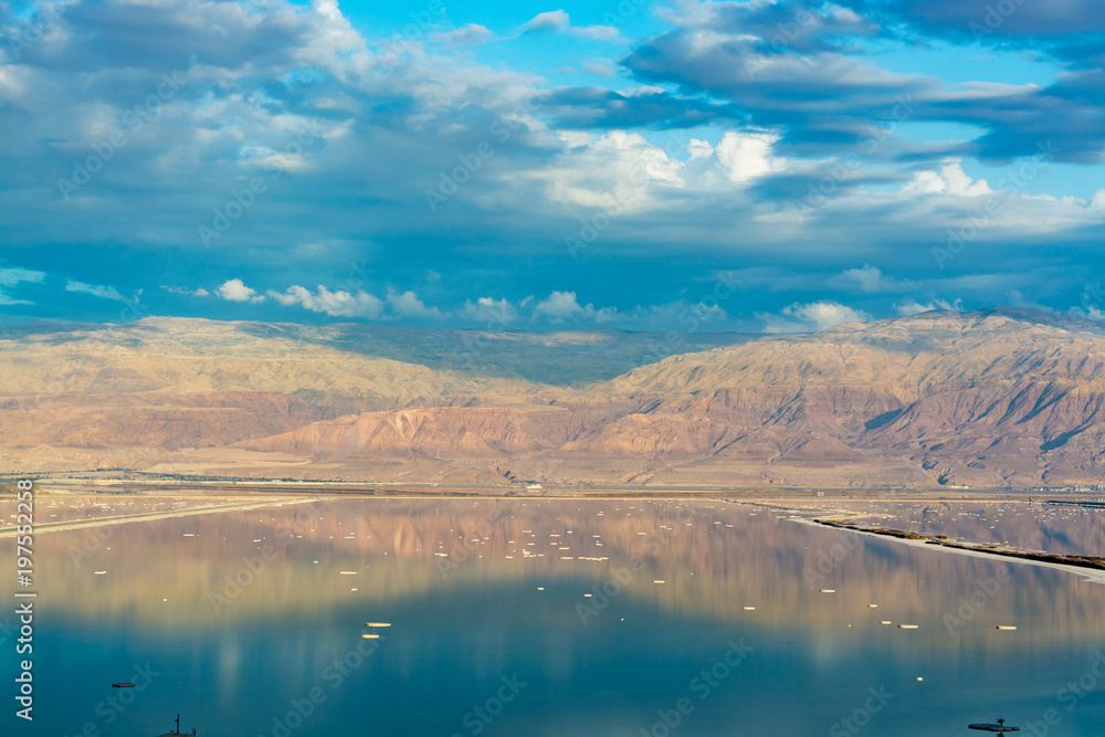 Landscape with water and Jordan mountains reflection, lowest salty lake in world below sea level Dead sea, Israel