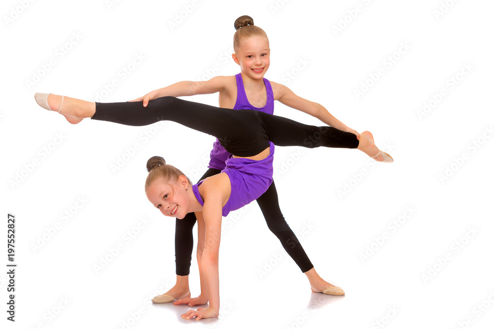 Girls gymnasts perform exercises. Girls gymnasts perform exercises.