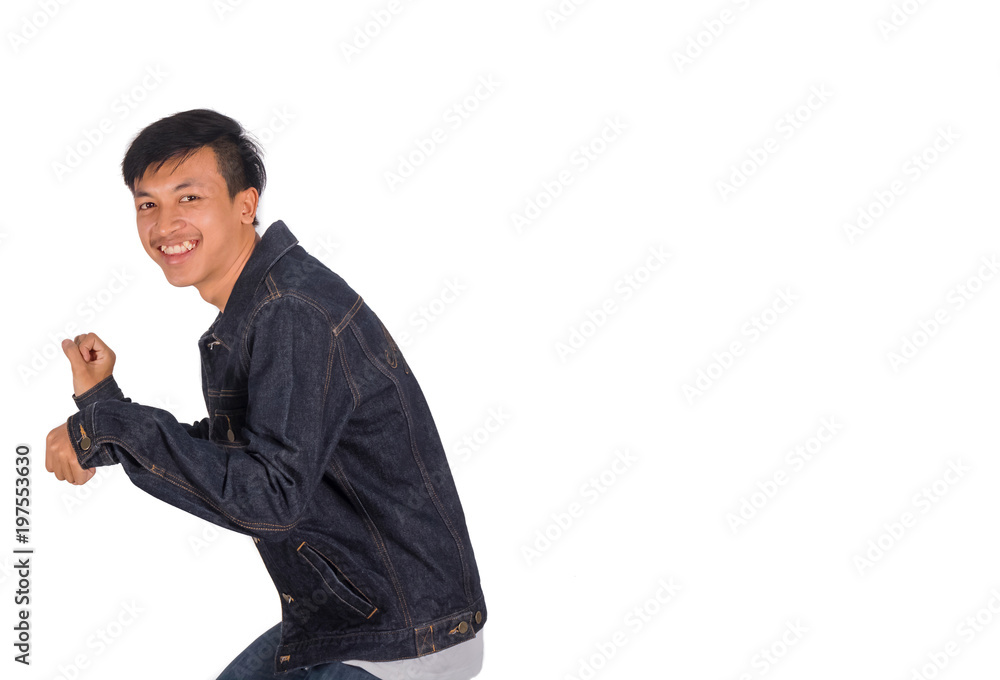 A Thai boy in jeans jacket demonstrates motorbike riding isolation. A Thai boy in jeans jacket demonstrates motorbike riding isolation.