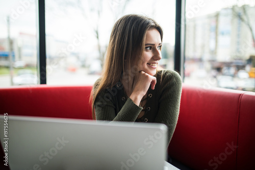 Beautiful young woman using laptop at cafe Free Download Beautiful young woman using laptop at cafe - GFXLoad