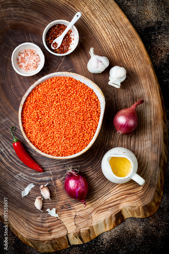 Fototapeta Naklejka Na Ścianę i Meble -  Cooking traditional red lentil Dal. Ingredients for Indian Dhal spicy curry. Top view, overhead