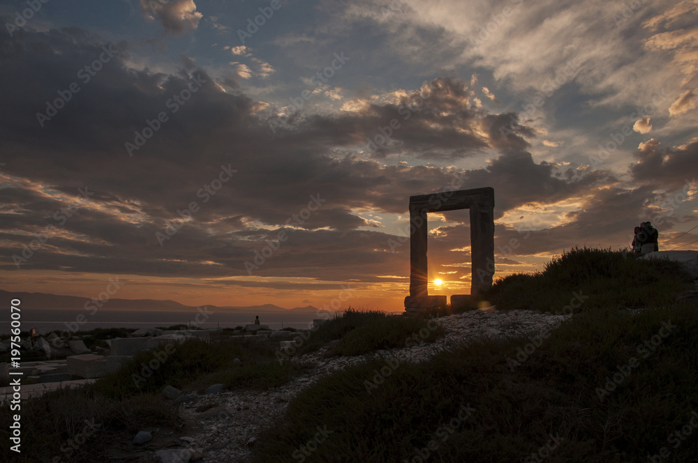 Sunset through Portara monument at Naxos island in Greece