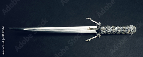 Metal sword on black background