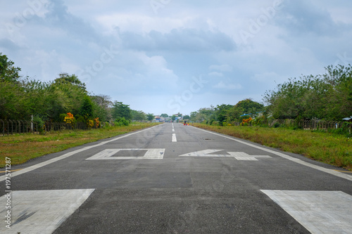 Fotografie runway on small airfield in rural landscape with people