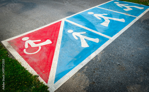 Traffic sign paint on asphalt road for wheelchair or pedestrian walk © Artinun