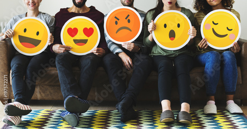 Group of diverse people holding emoticon icons photo