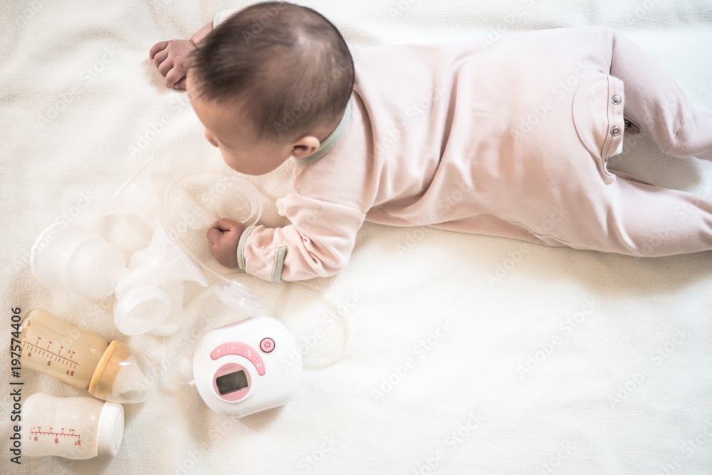 Top view Breast pump equipment and bottle of breast milk for new born baby with Baby Top view Breast pump equipment and bottle of breast milk for new born baby with Baby