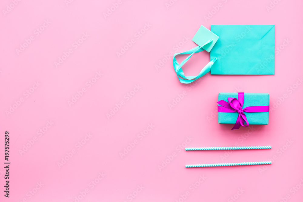 Gift box and colorful paper bag on pink background top view mock-up