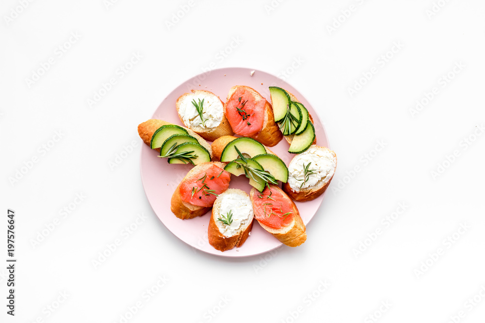 Mini sandwich set with french baguette, cheese, fish and avocado on white background top view mock up Mini sandwich set with french baguette, cheese, fish and avocado on white background top view mock up