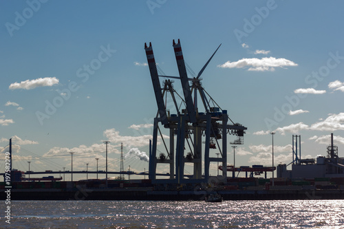 hamburg elbbruecken named river bridges container terminal docks boats and ships details and blue sky photo