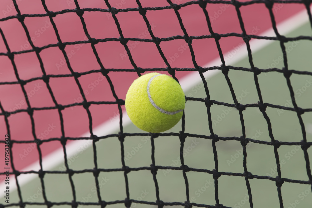 Tennis ball hitting the tennis net at tennis court with copy space.