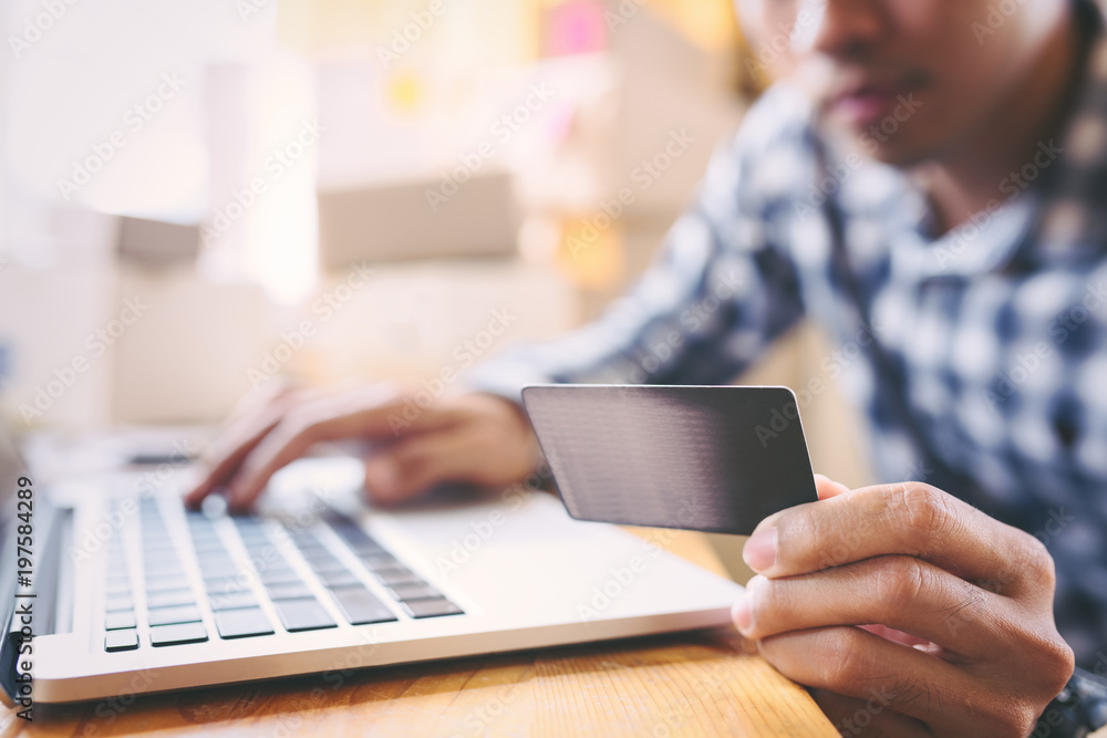 Young asian entrepreneurs man hands holding credit card for online shopping at home,teenager owner business,success and online shopping concept. Young asian entrepreneurs man hands holding credit card for online shopping at home,teenager owner business,success and online shopping concept.