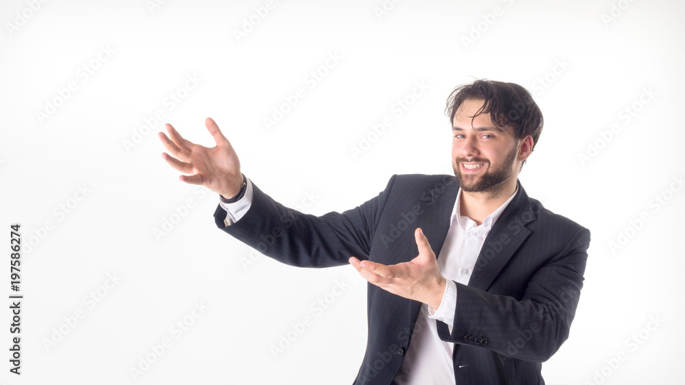 Happy smiling young man with a phone presenting and showing your text or product isolated on white background. Happy smiling young man with a phone presenting and showing your text or product isolated on white background.