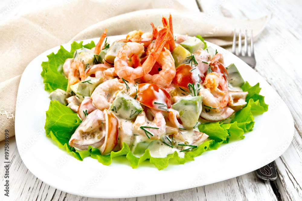Salad with shrimp and tomato in plate on light board Salad with shrimp and tomato in plate on light board
