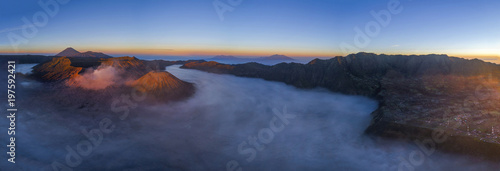 Aerial Panoramic view of Mount Bromo covered with mist at sunrise, Indonesia
