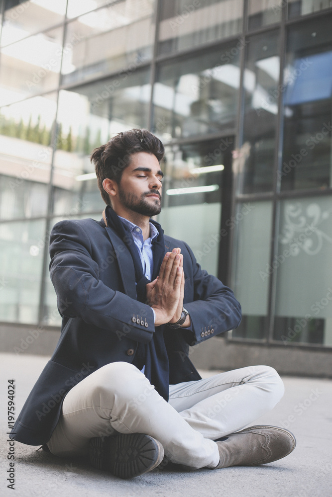 Caucasian businessman practicing yoga on sidewalk Caucasian businessman practicing yoga on sidewalk