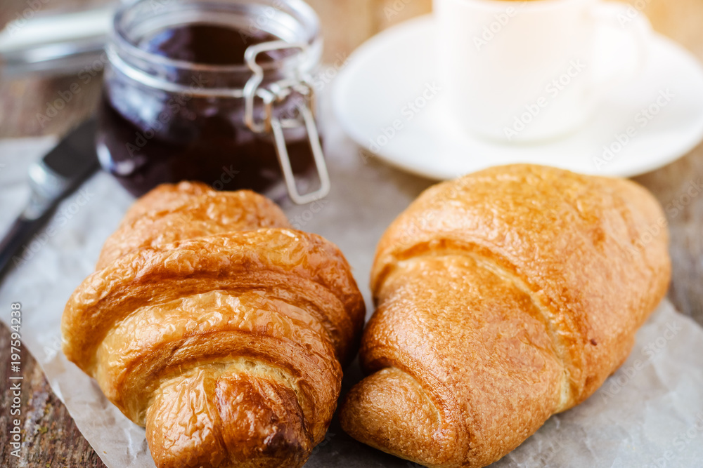 Two croissants and a cup of coffee