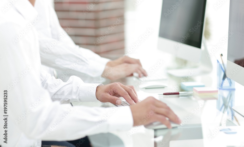 hands typing text on the computer keyboard. blurred business background. hands typing text on the computer keyboard. blurred business background.