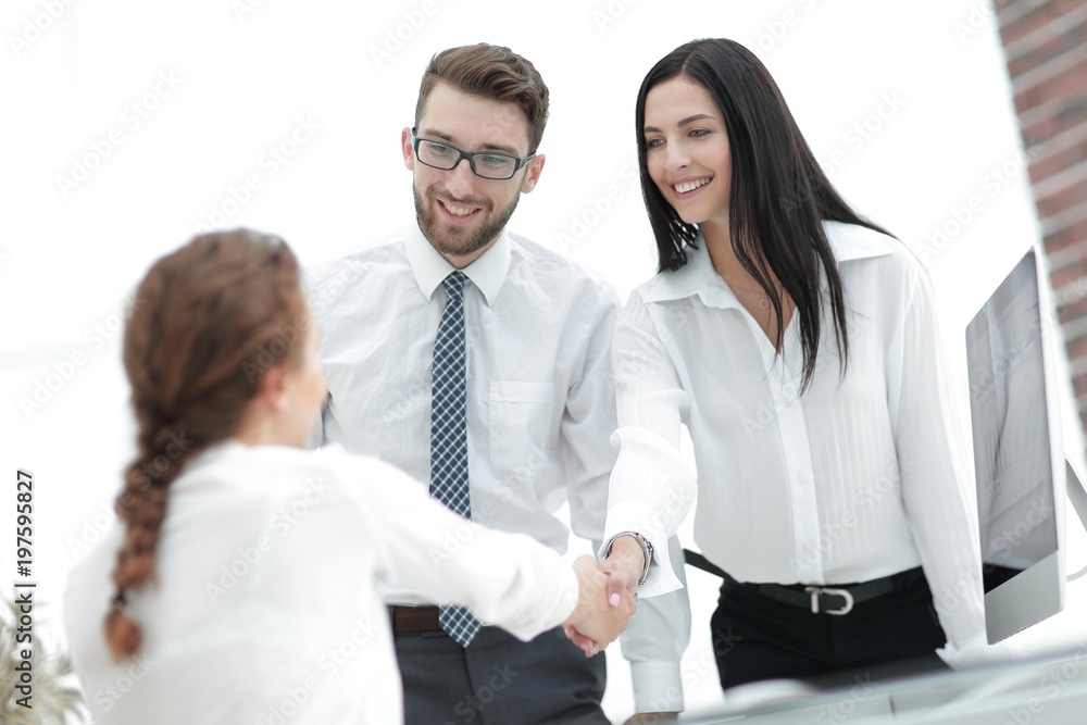 young business woman shaking hands with a colleague young business woman shaking hands with a colleague