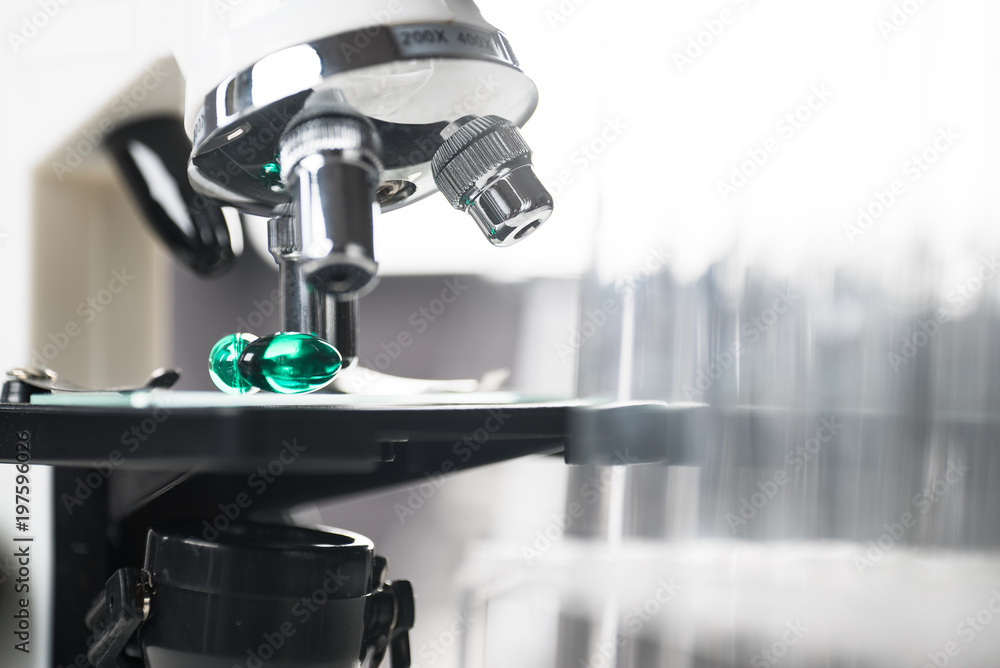 Laboratory Microscope, pills and test tubes. Scientific and healthcare research background. Laboratory Microscope, pills and test tubes. Scientific and healthcare research background.