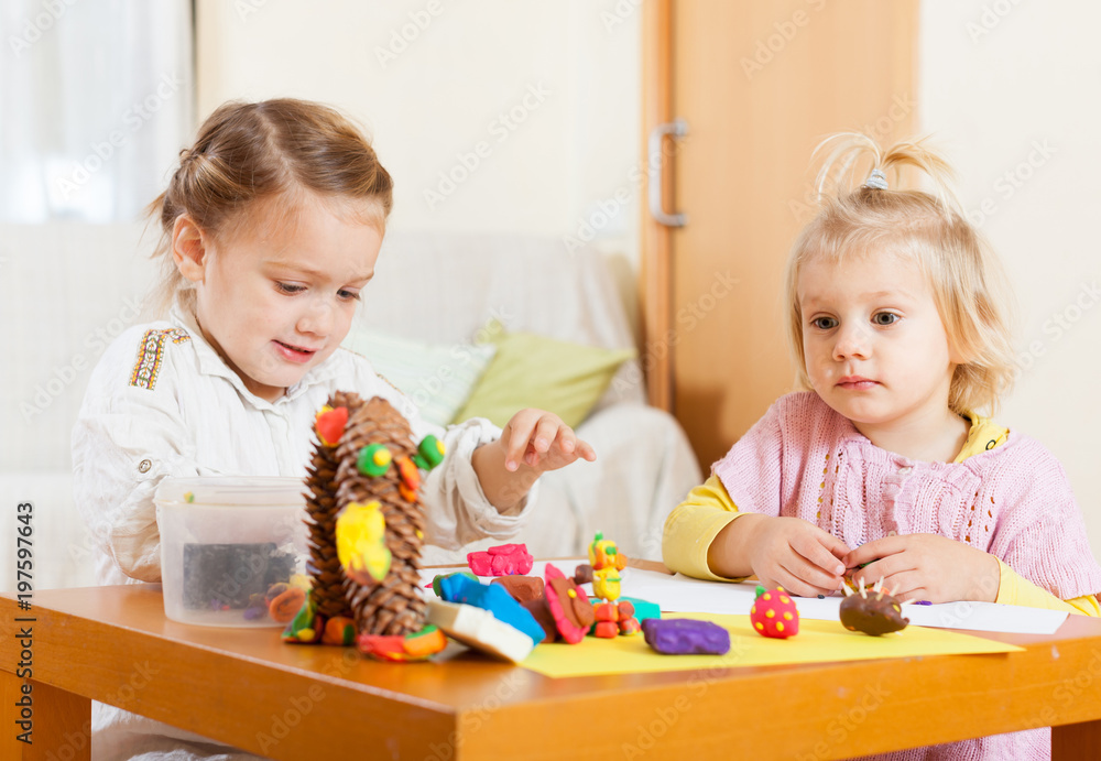 girls playing with plasticine girls playing with plasticine
