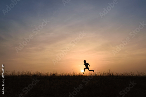 Kid running across the horizon at sunrise © Divyesh