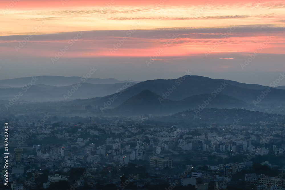 Fototapeta premium Mountain layers, sunrise and city