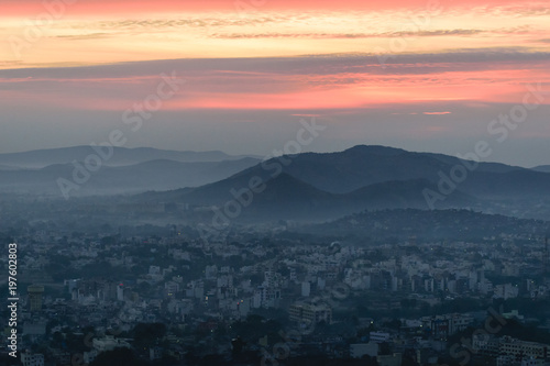 Mountain layers, sunrise and city © Divyesh