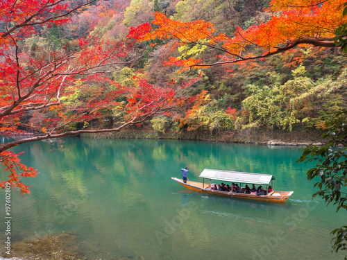 Red maple leaf with tourism in the boat when autumn in Arashiyama, Kyoto.