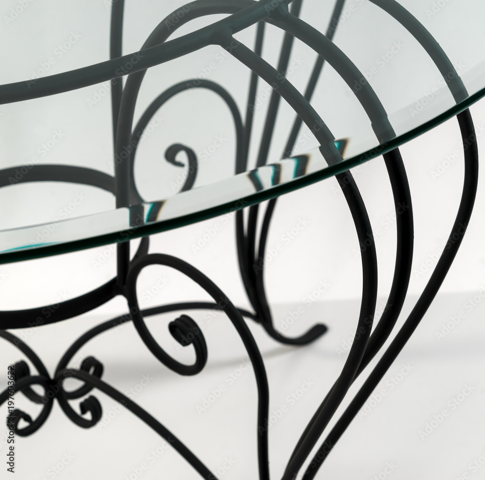 Beautiful curved ornaments of wrought iron. Detail of table Beautiful curved ornaments of wrought iron. Detail of table