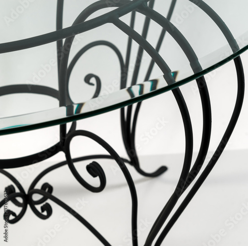 Beautiful curved ornaments of wrought iron. Detail of table