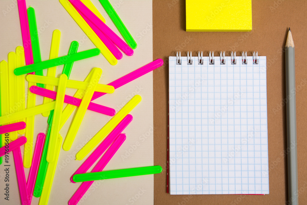Clean notebook and colorful counting sticks Clean notebook and colorful counting sticks
