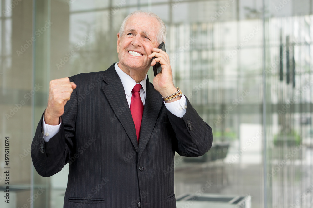 Cheerful Senior Banker Talking on Phone Outside Cheerful Senior Banker Talking on Phone Outside