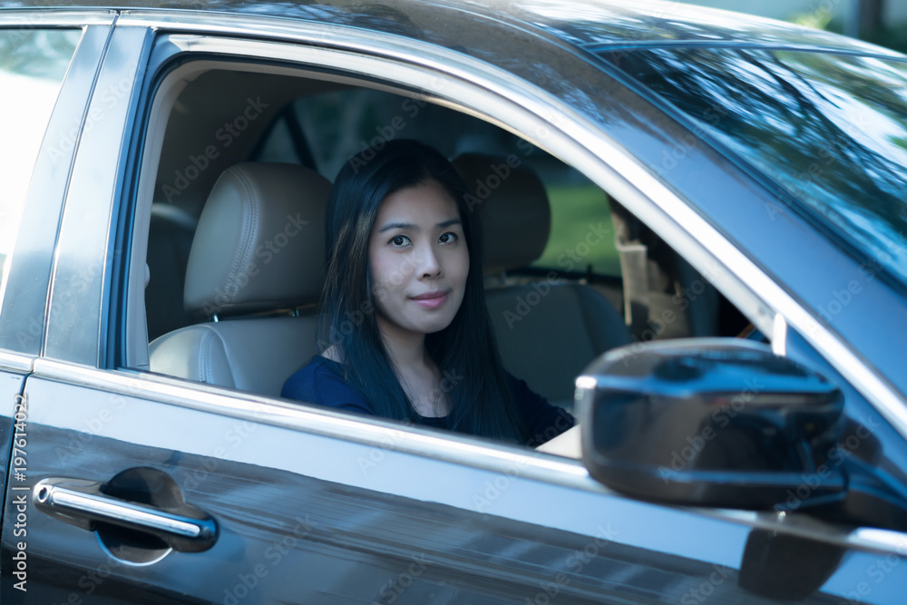 Asian woman drive her car.