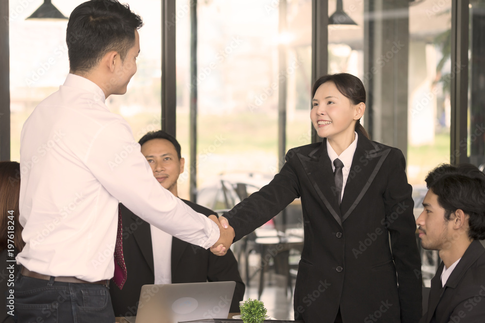 Business team are showing unity with their handshake together. Business team are showing unity with their handshake together.