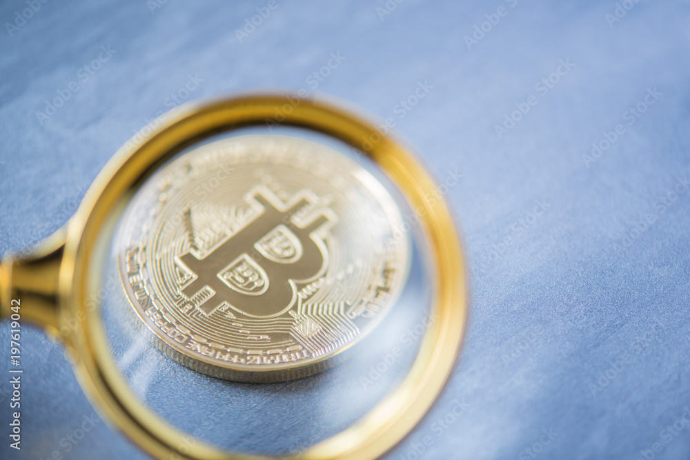 Viewing and the increase in bitcoin through a magnifying glass. electronic money Viewing and the increase in bitcoin through a magnifying glass. electronic money