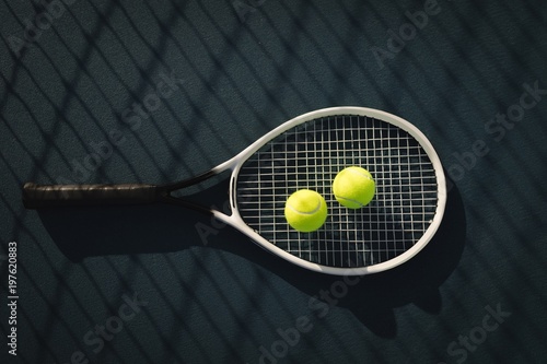 Tennis ball and racket in tennis court
