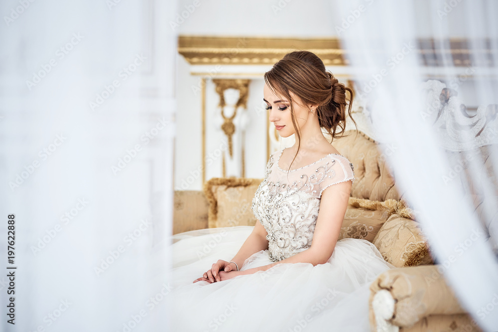 Beautiful sexy bride in white dress posing under curtain Beautiful sexy bride in white dress posing under curtain