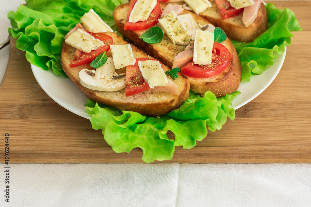 Italian bruschetta with chicken, tomatoes, mushrooms, cheese brie Italian bruschetta with chicken, tomatoes, mushrooms, cheese brie