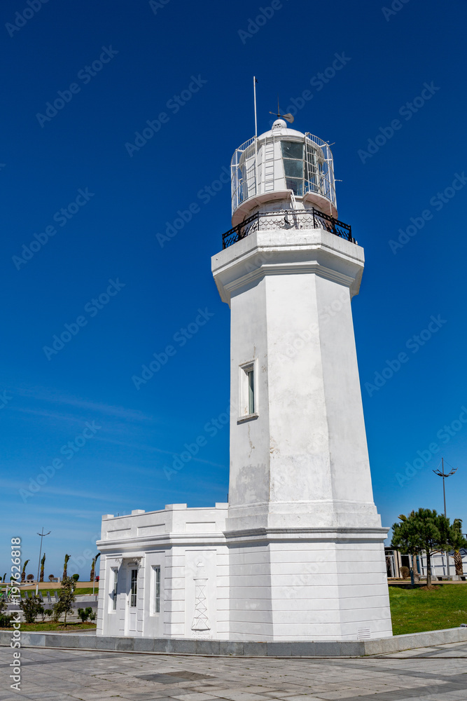 BATUMI, GEORGIA - MARCH 17, 2018: A snow-white lighthouse on the waterfront in Wonder Park. Built in 1863
