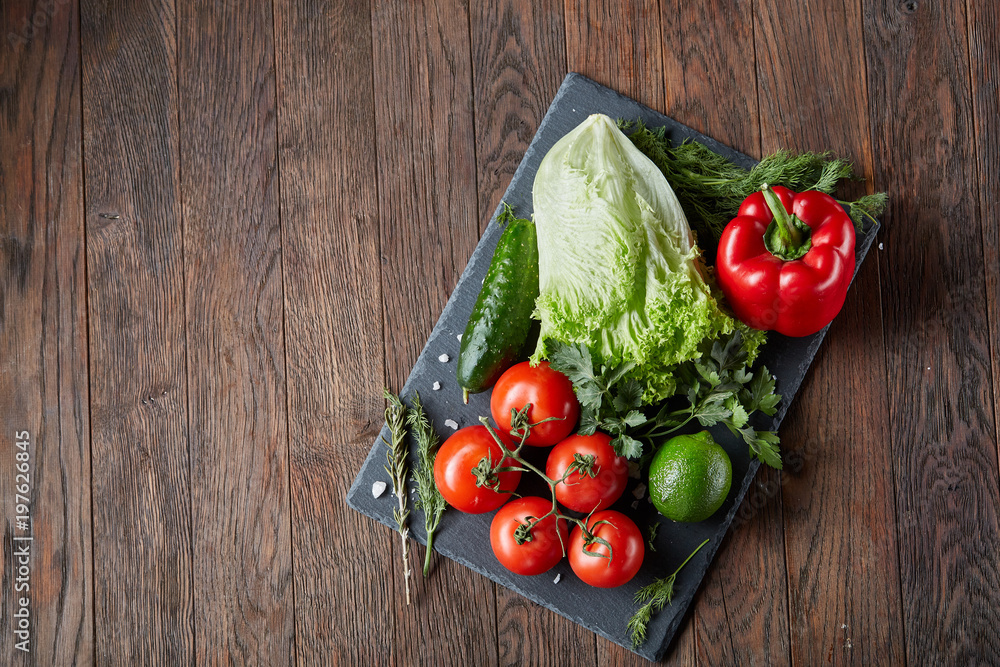 Vegetarian still life of assorted fresh vegetables and herbs on vintage wooden background, top view, selective focus. Vegetarian still life of assorted fresh vegetables and herbs on vintage wooden background, top view, selective focus.
