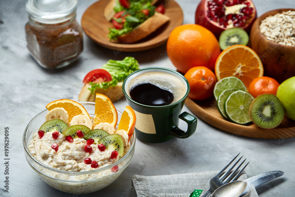 Breakfast still life with oatmeal porridge, fruits and coffee cup, top view, selective focus, shallow depth of field. Breakfast still life with oatmeal porridge, fruits and coffee cup, top view, selective focus, shallow depth of field.