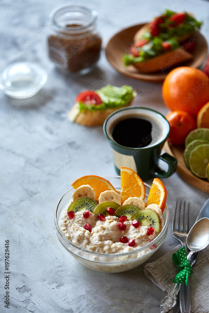 Breakfast still life with oatmeal porridge, fruits and coffee cup, top view, selective focus, shallow depth of field. Breakfast still life with oatmeal porridge, fruits and coffee cup, top view, selective focus, shallow depth of field.