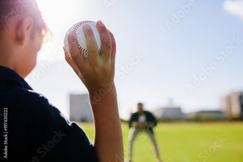 Sticker Boy playing with a baseball at a park
